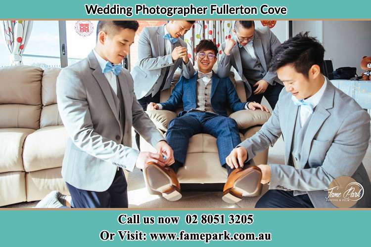 Photo of the Groom helping by the groomsmen getting ready Fullerton Cove NSW 2318