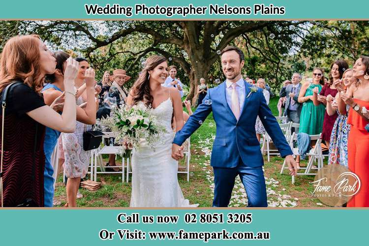 Photo of the Bride and the Groom showering bubbles by the visitors Nelsons Plains NSW 2324